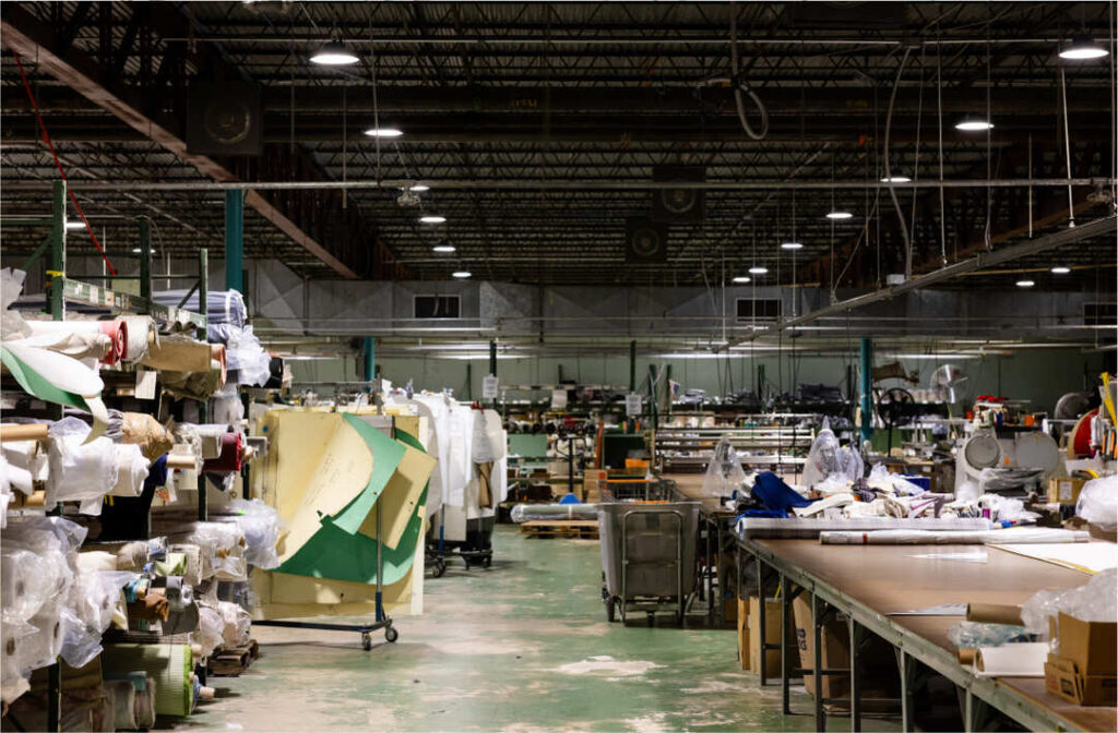 View of cushion pros factory interior with worktables, fabrics and sewing machines