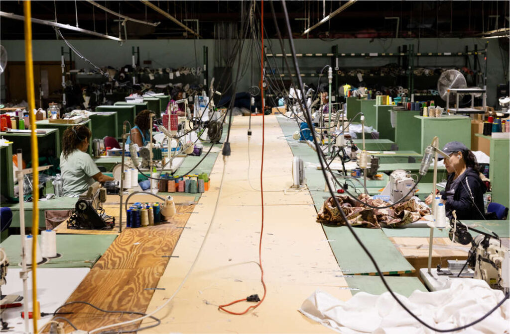 Skilled craftsman sewing custom cushions at cushion pros factory